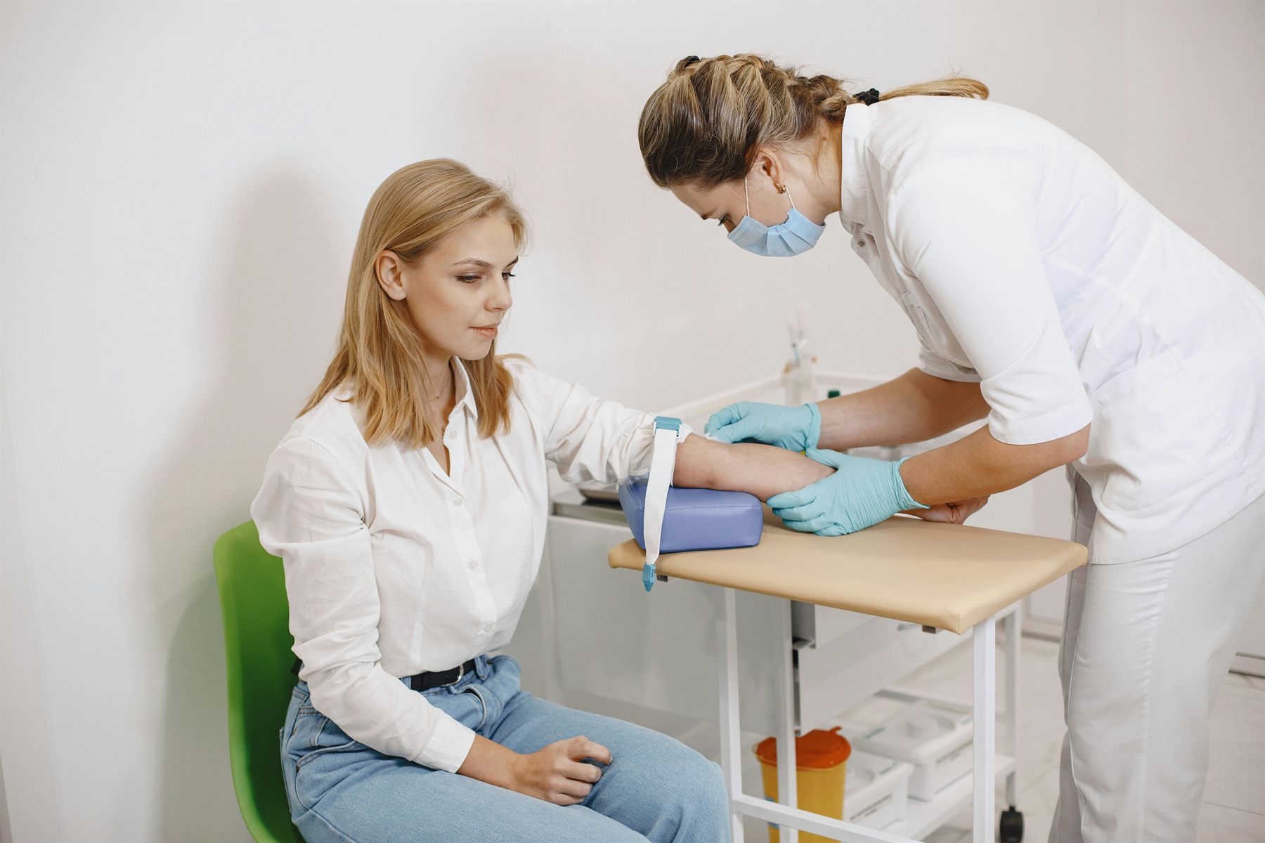 Professional phlebotomy blood draw in a clinical setting.
